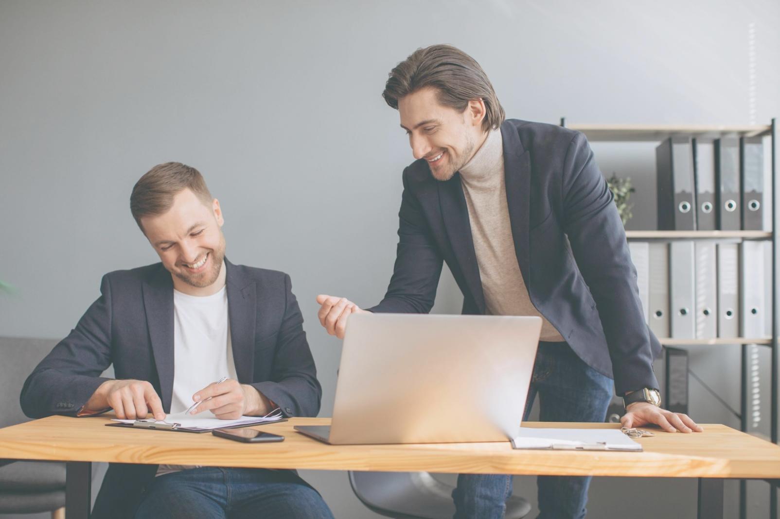 Financial professionals collaborating on software analysis in modern workspace